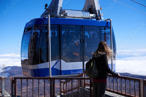 Young woman with a cableway on the top of the Teide volcano in Tenerife, Spain