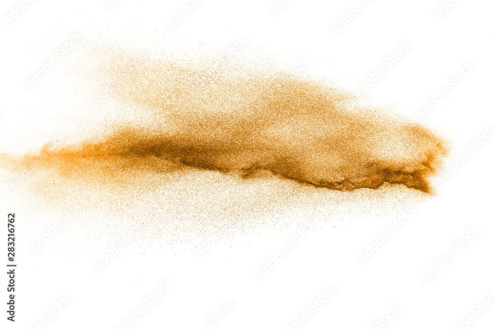 Abstract orange powder explosion on white background. Freeze motion of orange dust particles splash.