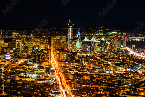 Night pnoramic view of San Francisco downtown with skyscrapers and Okeland Bridge photo