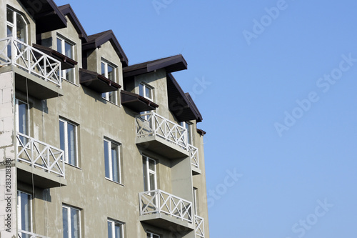 New modern block of flats on blue sky background