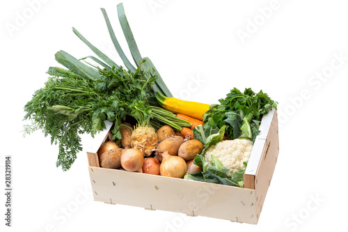 Wooden box of fresh vegetables from farmers market on white painted wood table.