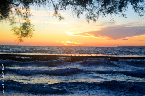 Natural sunset over sea horizon. Summer holiday background.