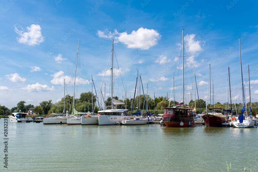 Sailing boats parking in the harbour on a hot summer day.