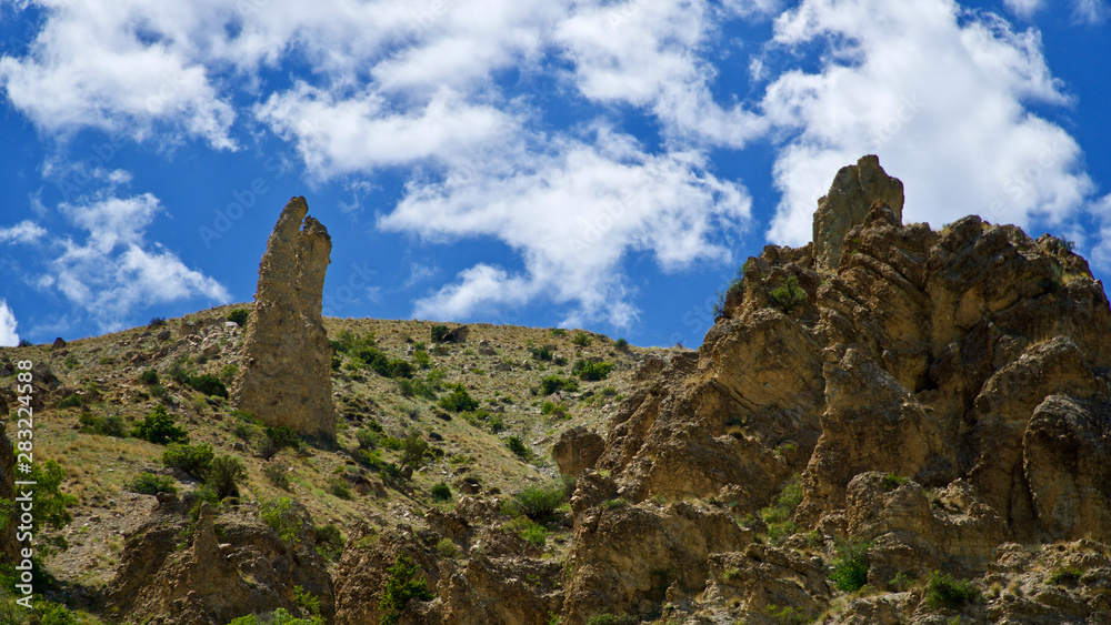 Curving roads in a green nature with pointed and steep rocks