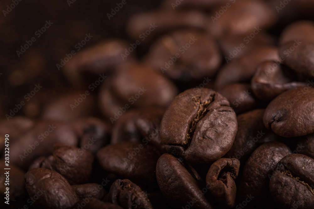 Coffee beans on stone background. Top view with copy space for your text. Roasted coffee beans background. Beans texture, macro Coffee beans on stone background. Top view with copy space for your text. Roasted coffee beans background. Beans texture, macro
