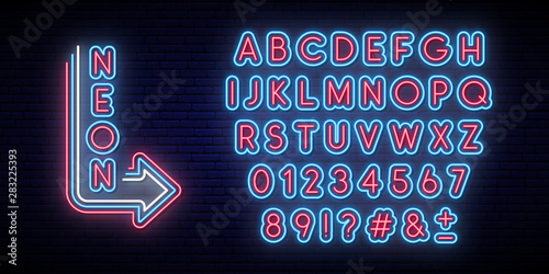Neon glowing alphabet. Bright typeface. Set of neon letters and numbers. Alphabet on dark background.