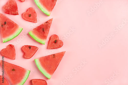 Red watermelon pattern. Creative layout made in shape of heart of fresh watermelon on pastel pink background. Summer, food concept. Flat lay, top view, copy space Minimal style