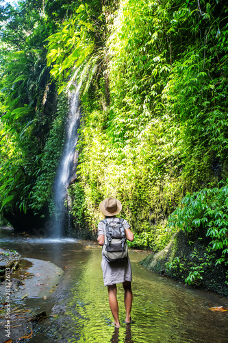 Woman near waterfal on Bali  Indonesia  