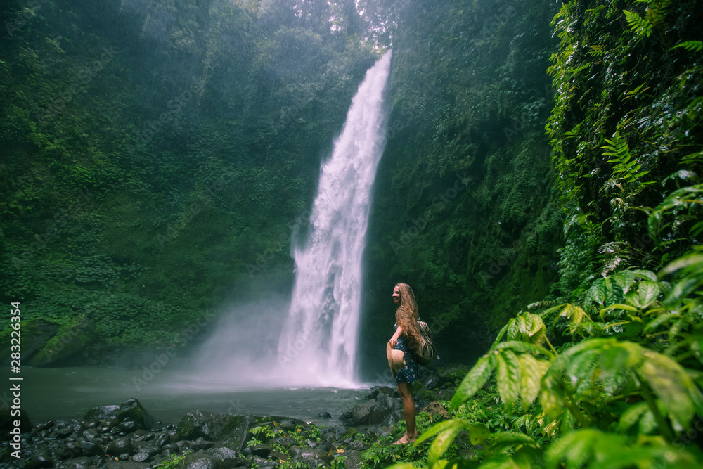 Woman near Nung Nung waterfal on Bali, Indonesia Woman near Nung Nung waterfal on Bali, Indonesia