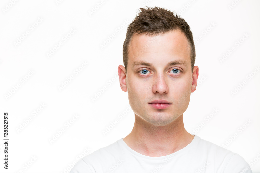 Portrait of a handsome young man, perfectly calm, facing the camera with emotionless expression Portrait of a handsome young man, perfectly calm, facing the camera with emotionless expression