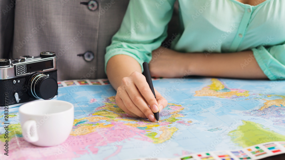 Couple studying world map and marking city to visit Couple studying world map and marking city to visit