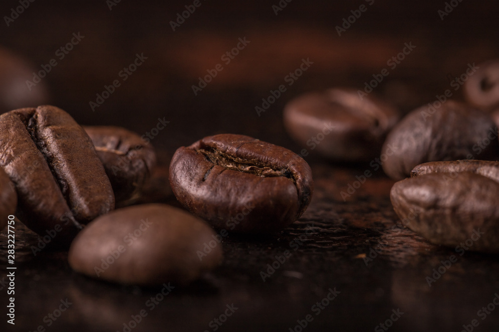 Coffee beans on stone background. Top view with copy space for your text. Roasted coffee beans background. Beans texture, macro Coffee beans on stone background. Top view with copy space for your text. Roasted coffee beans background. Beans texture, macro
