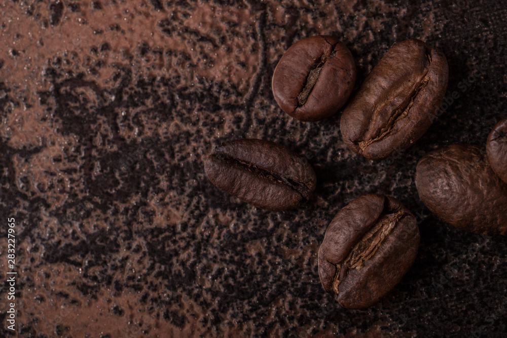 Coffee beans on stone background. Top view with copy space for your text. Roasted coffee beans background. Beans texture, macro Coffee beans on stone background. Top view with copy space for your text. Roasted coffee beans background. Beans texture, macro