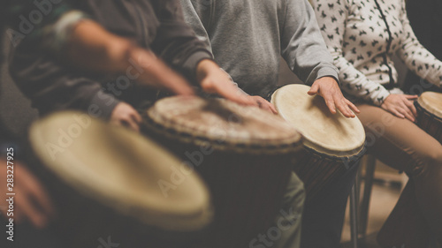 Group of people playing on drums - therapy by music