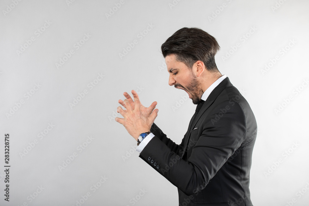 Angry businessman screaming and throwing hands Angry businessman screaming and throwing hands