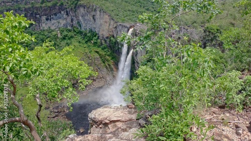 High waterfall in green canyon forest with rainbow - 2x speed