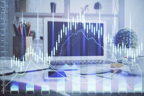Stock market chart hologram drawn on personal computer background. Double exposure. Concept of investment.