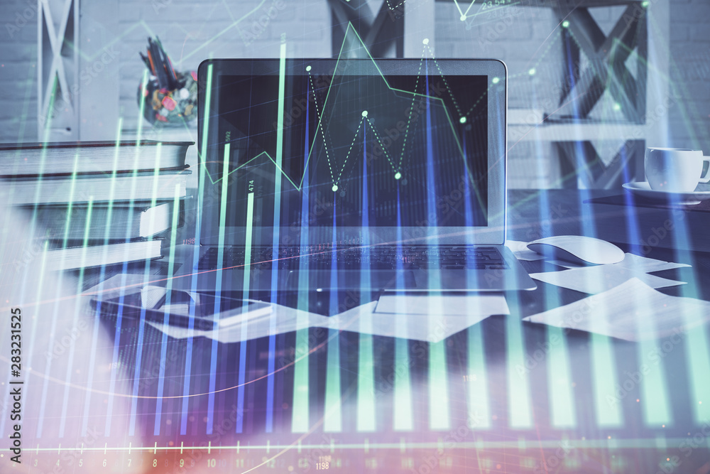 Forex market chart hologram and personal computer background. Multi exposure. Concept of investment. Forex market chart hologram and personal computer background. Multi exposure. Concept of investment.