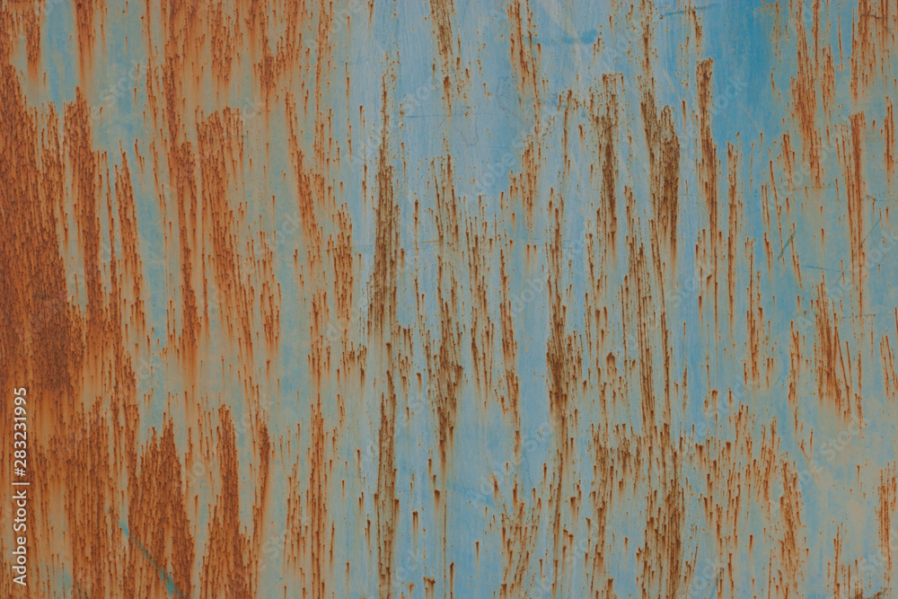 Abstract grunge background. Old rusty metal. Scratches and chips. Brown and blue colors.