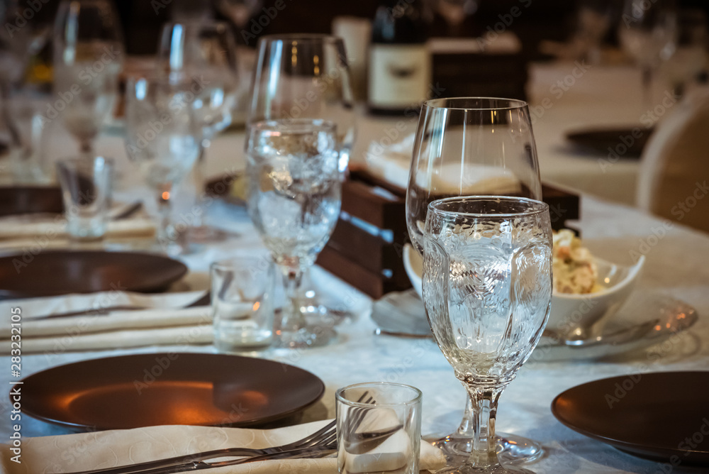 Table setting for a holiday before the arrival of people, selective focus Table setting for a holiday before the arrival of people, selective focus