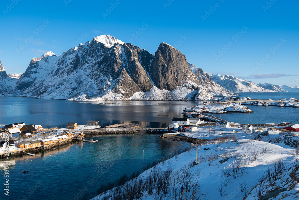 Fishermen’s cabins (rorbu) in the Hamnoy village under blue sky in winter season, Lofoten islands, Norway