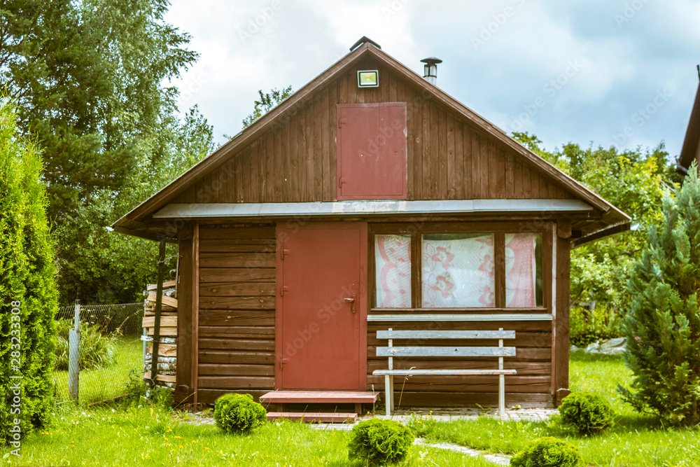 Old wooden house on a well-kept lawn Old wooden house on a well-kept lawn
