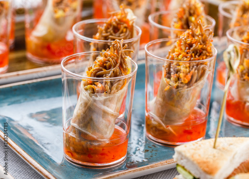 Delicious appetizers in glass cups on banquet table. Catering food  canape and snacks