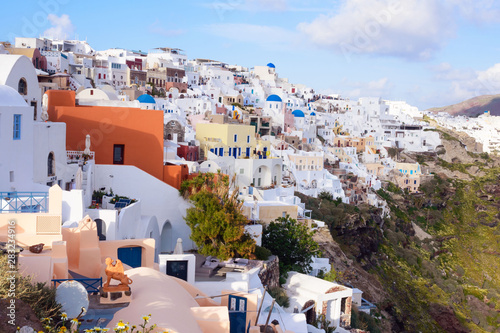 Beautiful island of Santorini, Greece. Traditional white greek houses against the backdrop of the sea. The city of Oia on the island of Santorini. Greek journey. Sunset.