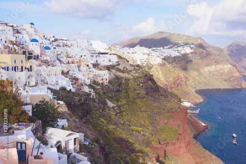 Beautiful island of Santorini, Greece. Traditional white greek houses against the backdrop of the sea. The city of Oia on the island of Santorini. Greek journey. Sunset.
