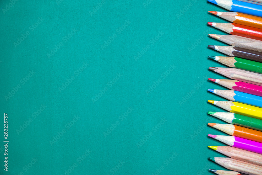 Colorful pencils on chalkboard Colorful pencils on chalkboard