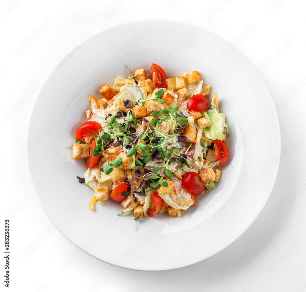 Caesar salad with lettuce, tomatoes, sprouts, croutons and sauce in plate on isolated white background. Healthy food, vegetarian dieting, top view Caesar salad with lettuce, tomatoes, sprouts, croutons and sauce in plate on isolated white background. Healthy food, vegetarian dieting, top view