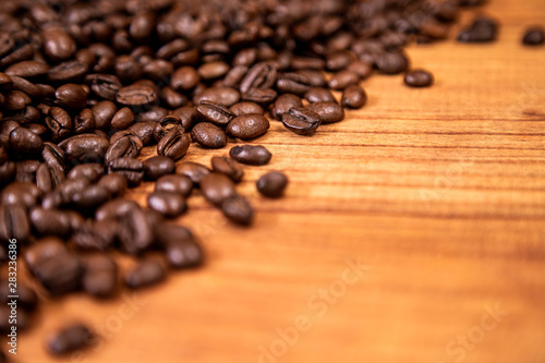 A coffee beans over wooden table top background.