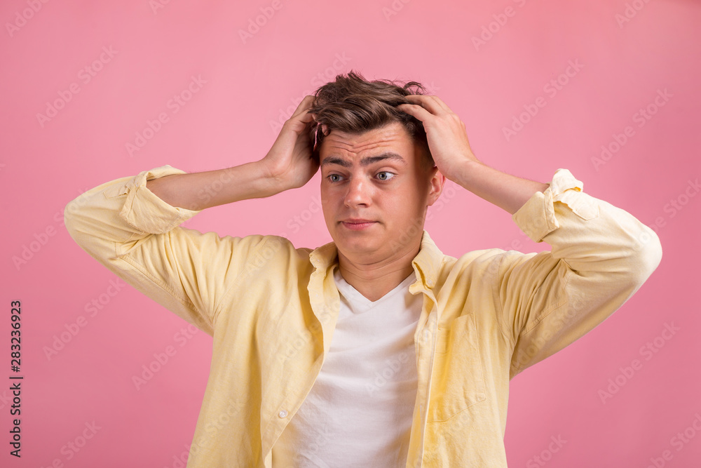 Portrait of young man with shocked facial expression on pink background Portrait of young man with shocked facial expression on pink background