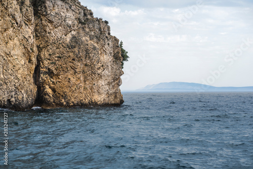 Sea Balkan atmospheric landscape with a rock going into the sea. Adriatic Sea