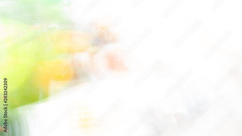 Abstract white background with green and yellow washed bokeh