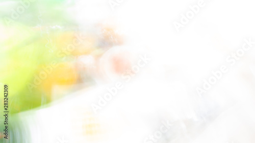 Abstract white background with green and yellow washed bokeh