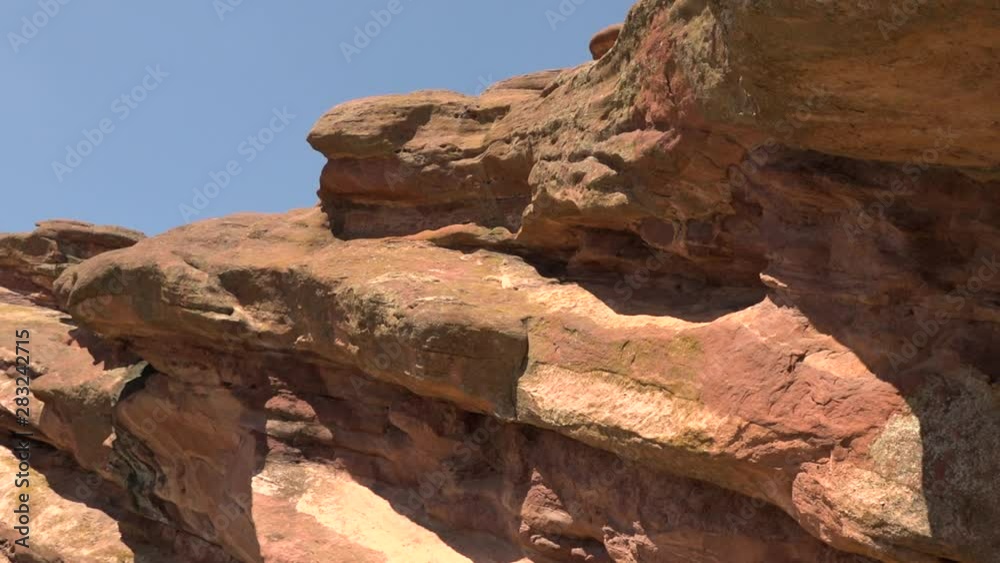 Close-up of red rock formation in front of a clear blue sky on a sunny day in Colorado Close-up of red rock formation in front of a clear blue sky on a sunny day in Colorado
