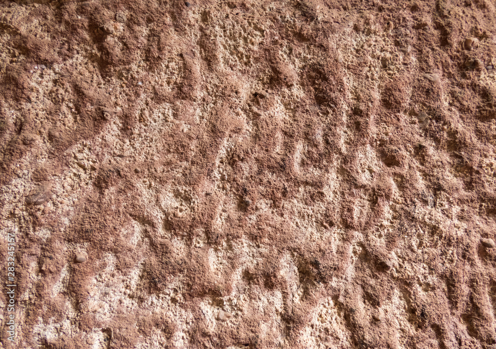 The texture of the brown old monastery wall with cracks and scuffs The texture of the brown old monastery wall with cracks and scuffs