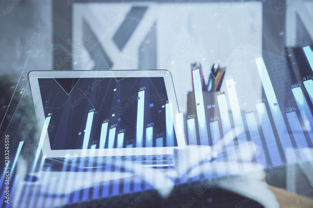 Stock market chart hologram drawn on personal computer background. Double exposure. Concept of investment. Stock market chart hologram drawn on personal computer background. Double exposure. Concept of investment.