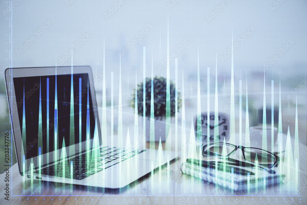 Forex Chart hologram on table with computer background. Double exposure. Concept of financial markets. Forex Chart hologram on table with computer background. Double exposure. Concept of financial markets.