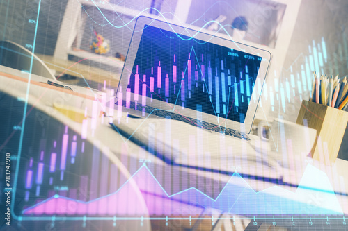 Financial chart drawing and table with computer on background. Double exposure. Concept of international markets. © peshkova