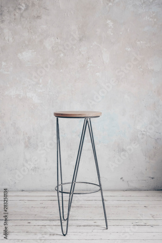 Wooden loft bar chair on the grey wall background