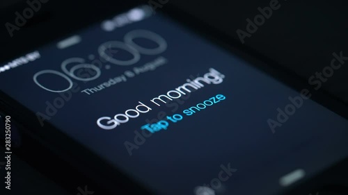 Good morning alarm clock on the phone in the dark room, detailed photo