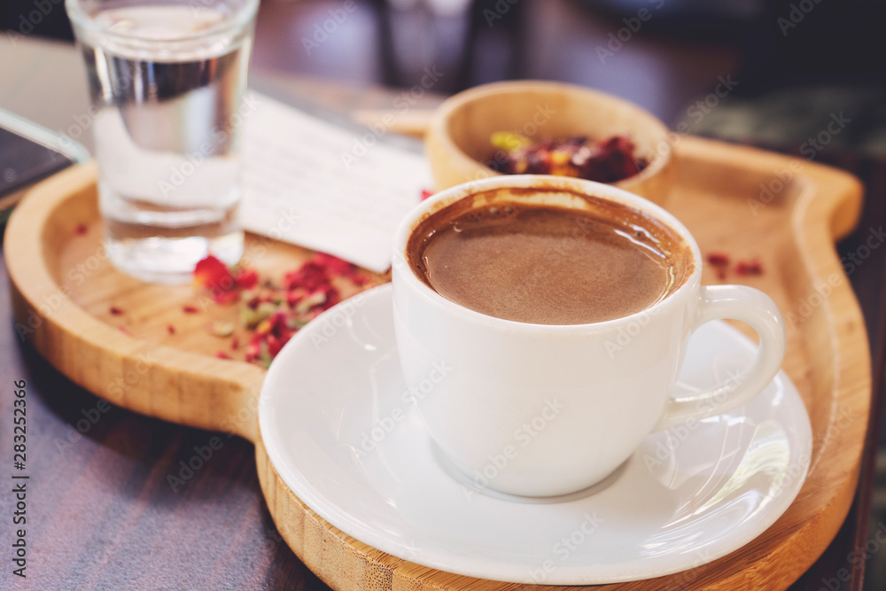 Traditional Turkish Coffee cup and Turkish delight concept with wooden background Traditional Turkish Coffee cup and Turkish delight concept with wooden background