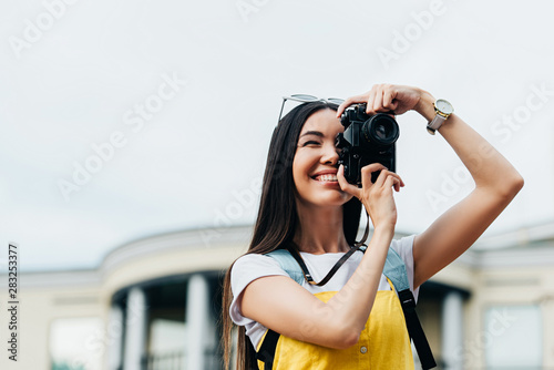 attractive and asian woman with glasses smiling and taking photo © LIGHTFIELD STUDIOS