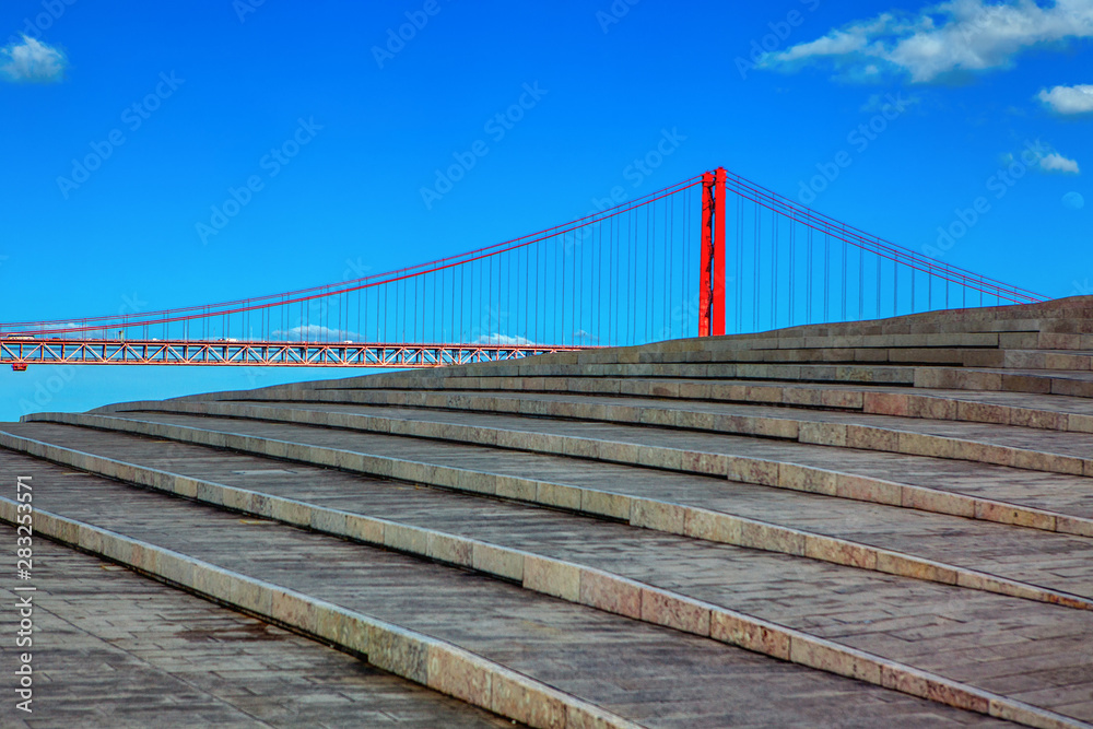 view of stone stairs and famous bridge in Lisbon view of stone stairs and famous bridge in Lisbon