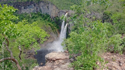 High waterfall in green canyon forest with rainbow - Zoom In