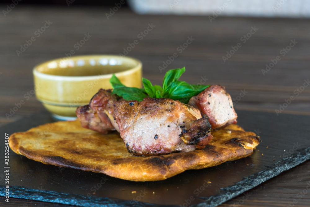 grilled pork steak. meat on pita bread