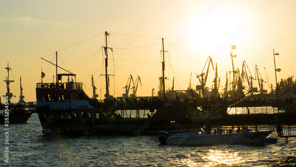 ship in the harbor,  ships at sunset. cranes in the port