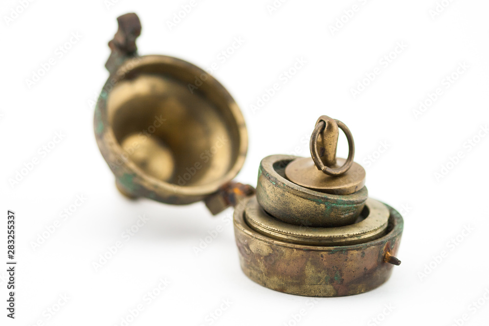 Antique set of weights patina brass on white background Antique set of weights patina brass on white background